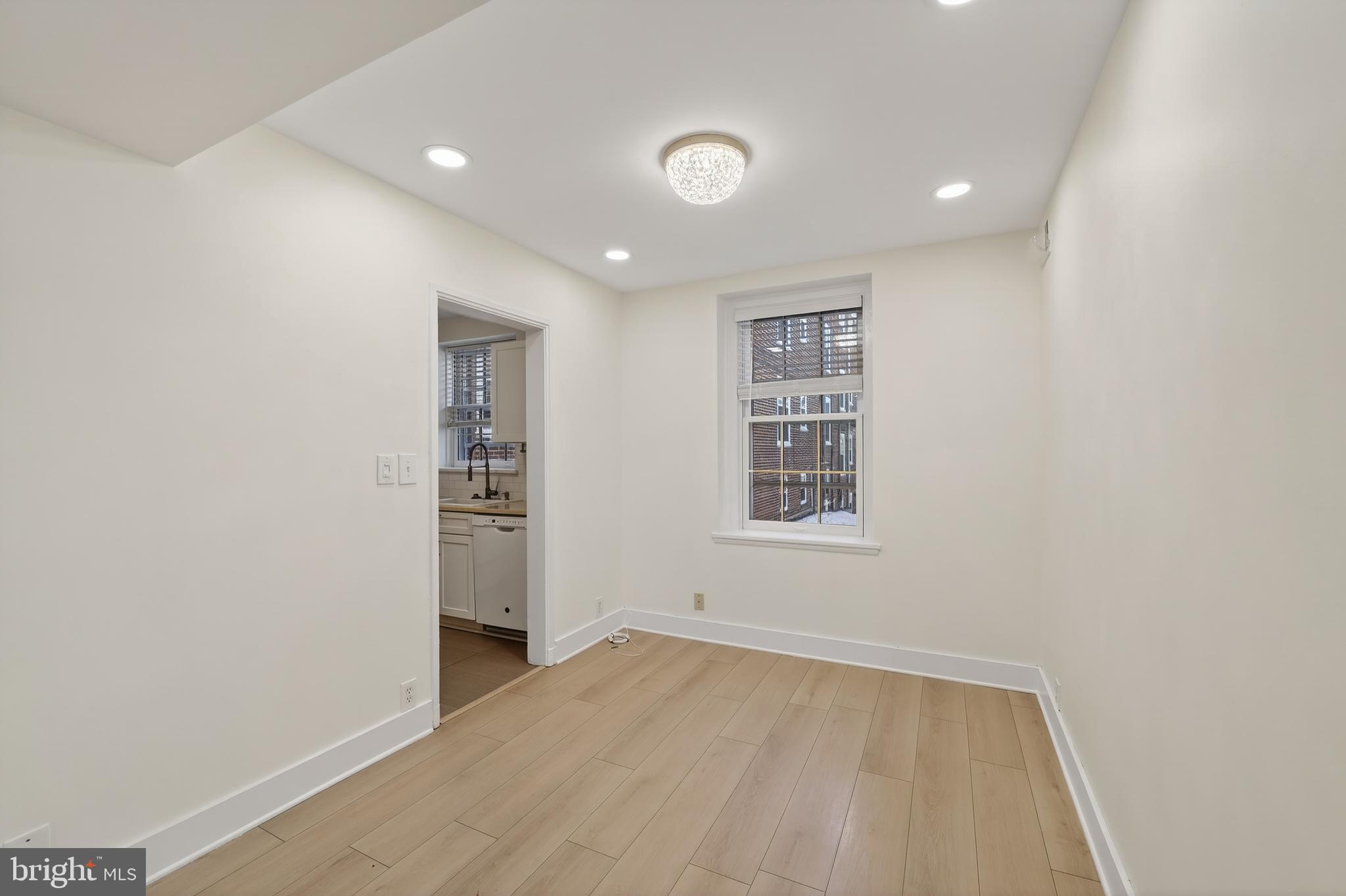 3450 39th Street Northwest, Unit A685 Washington, DC 20016 - Photo 10 of 30 an empty room with a hardwood and hallway