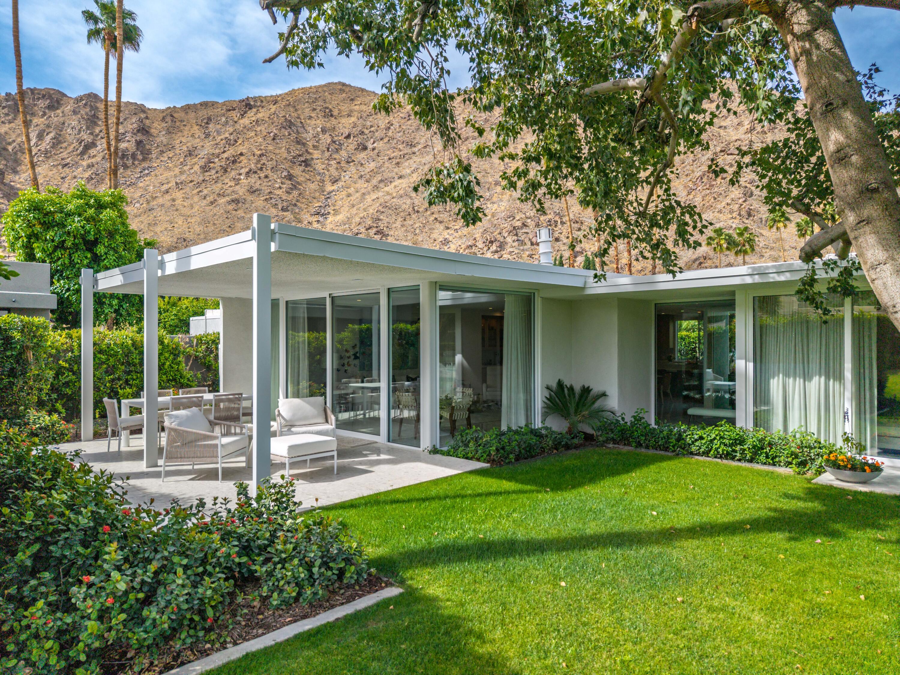 a front view of a house with garden and porch