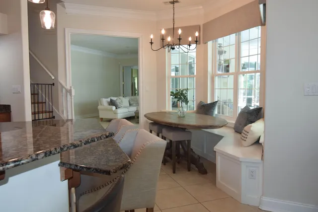 a view of a dining room with furniture and chandelier