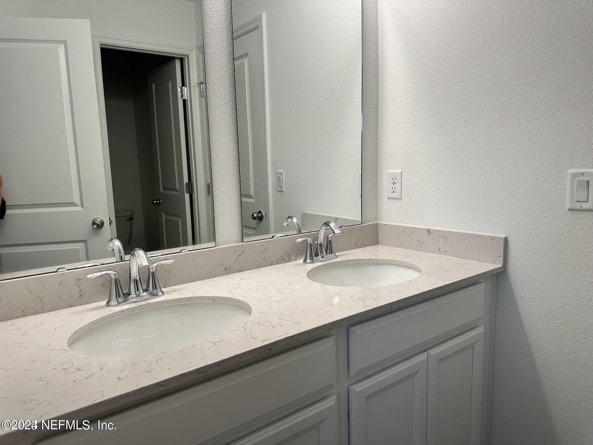 47 Beauclair Boulevard St. Augustine, FL 32084 - Photo 16 of 37 a bathroom with a sink and a mirror