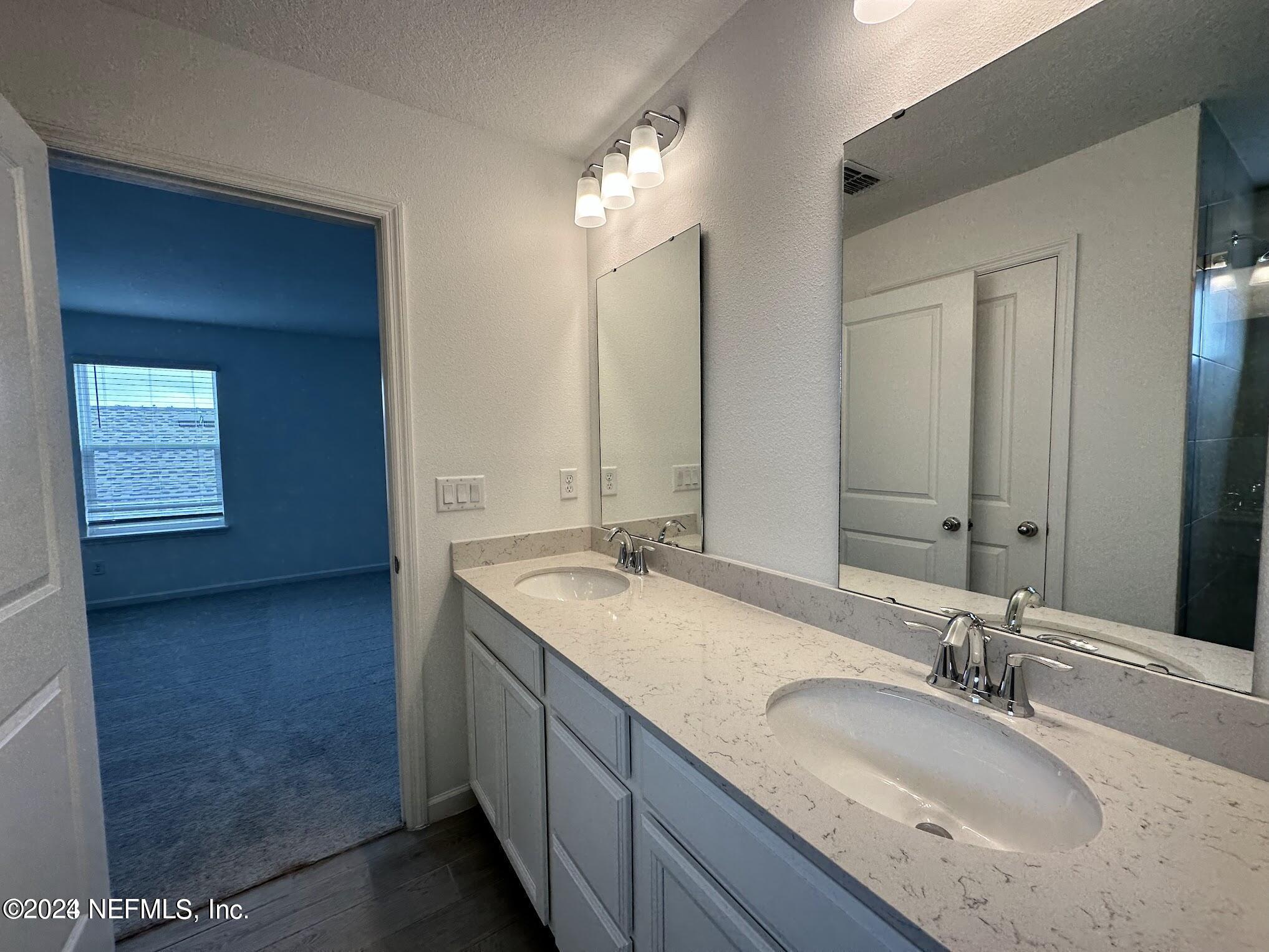 47 Beauclair Boulevard St. Augustine, FL 32084 - Photo 17 of 37 a bathroom with a granite countertop sink and a mirror