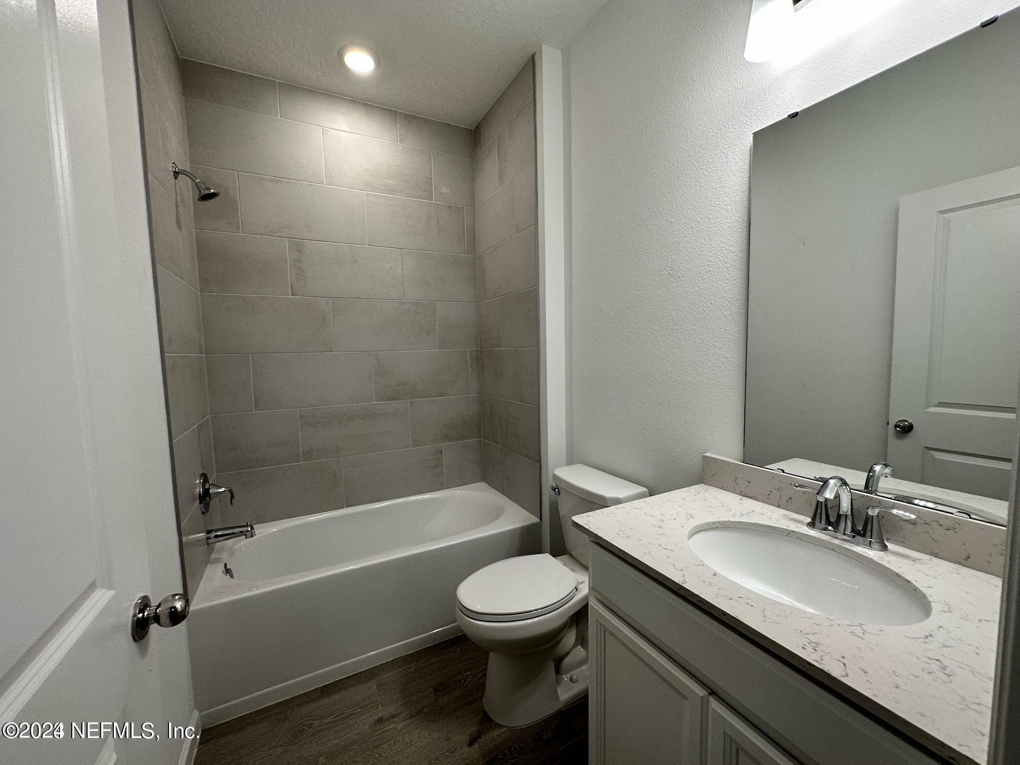 47 Beauclair Boulevard St. Augustine, FL 32084 - Photo 27 of 37 a bathroom with a sink a toilet and a mirror