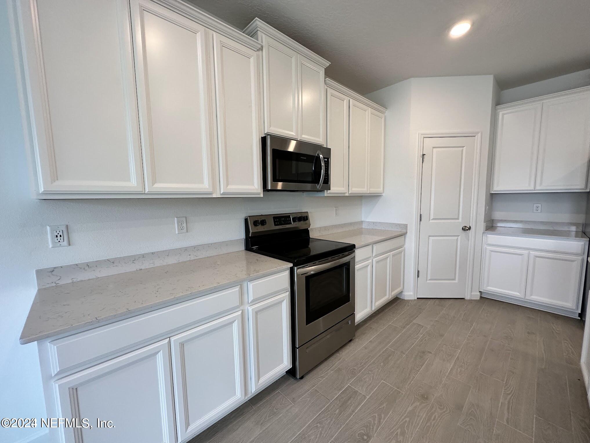 47 Beauclair Boulevard St. Augustine, FL 32084 - Photo 5 of 37 a kitchen with white cabinets and white appliances