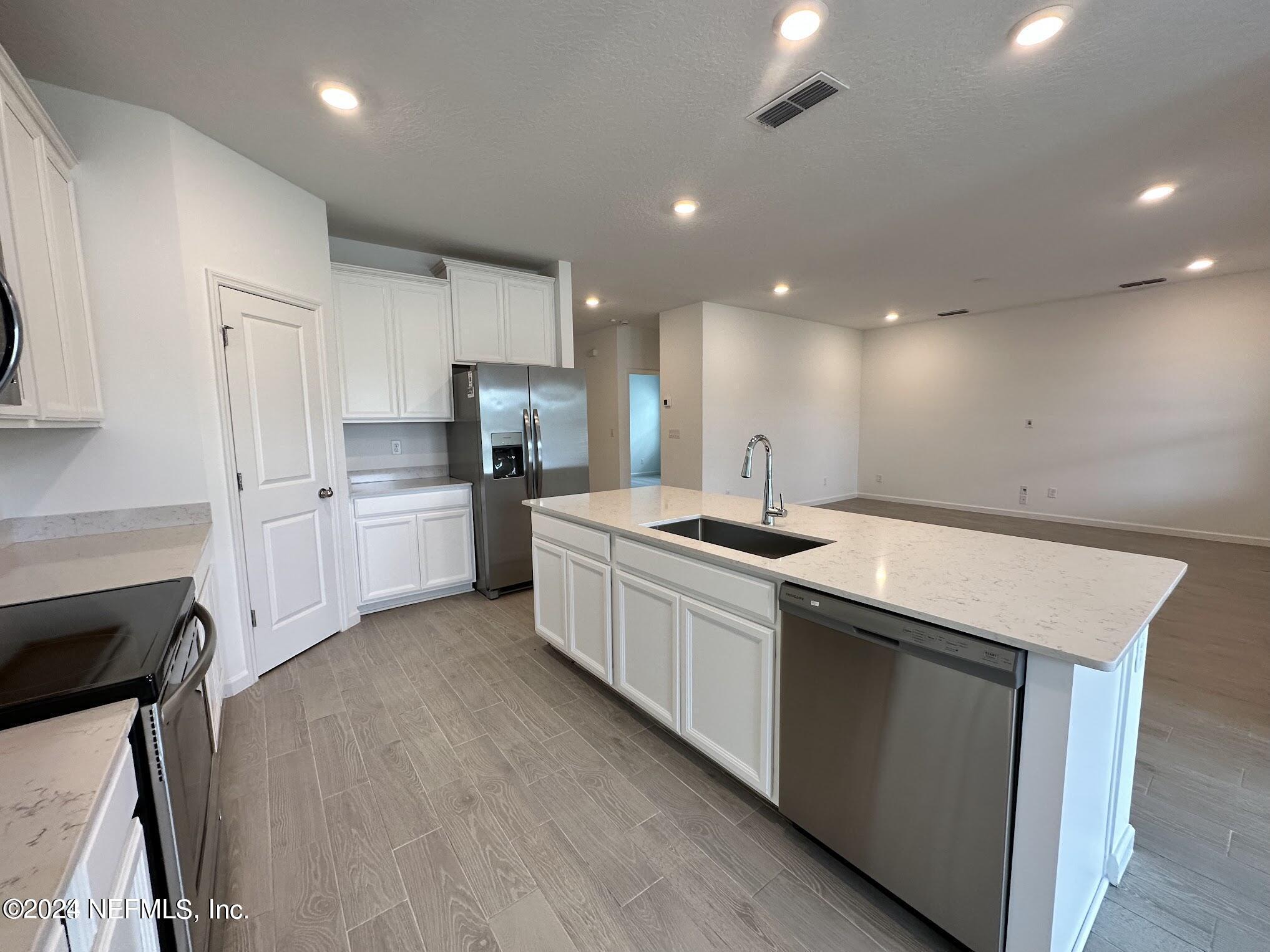 47 Beauclair Boulevard St. Augustine, FL 32084 - Photo 6 of 37 a large kitchen with stainless steel appliances kitchen island a large counter top and a stove top oven