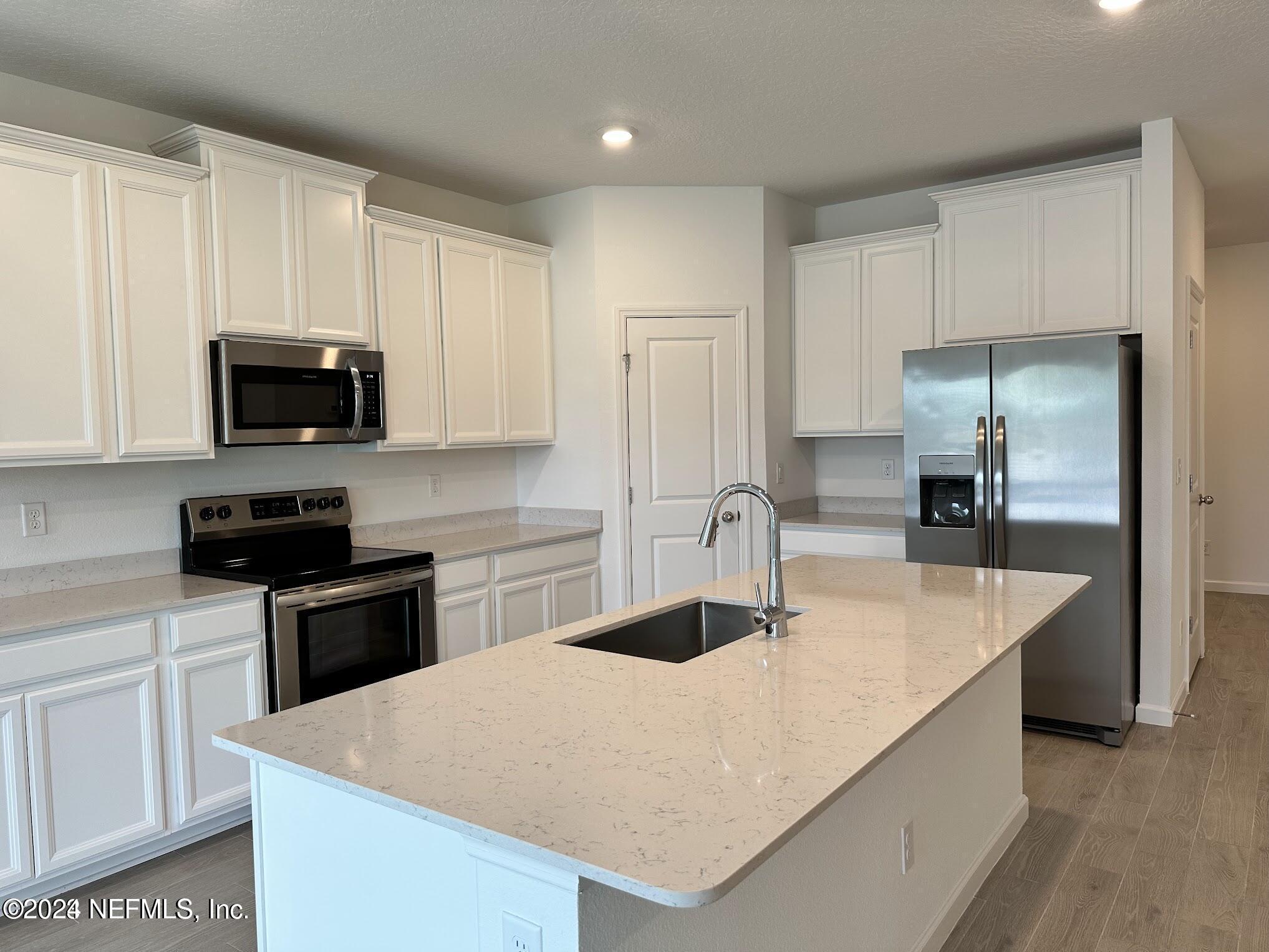 47 Beauclair Boulevard St. Augustine, FL 32084 - Photo 7 of 37 a kitchen with stainless steel appliances a stove refrigerator sink and cabinets