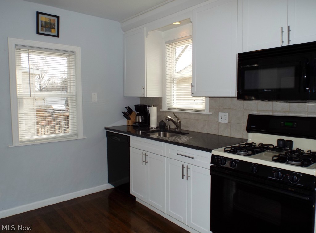 1264 Gordon Road Lyndhurst, OH 44124 - Photo 6 of 21 Beautifully updated kitchen with white cabinets, granite countertops, tiled backsplash.