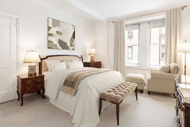 a living room with furniture a fireplace and a window