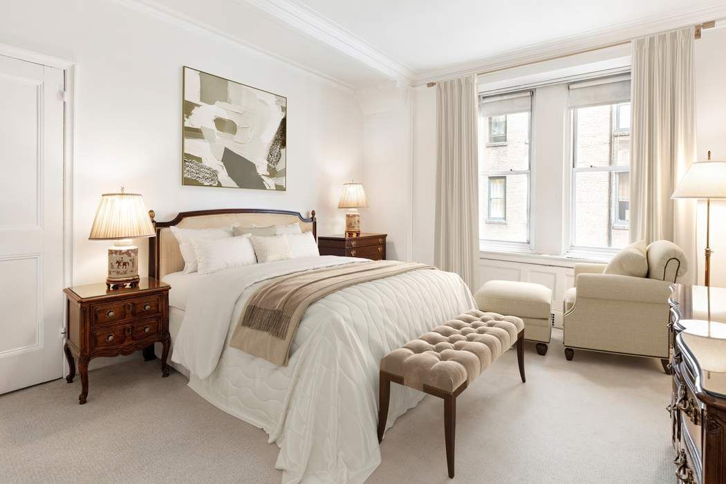 781 5th Avenue, Unit 614 Manhattan, NY 10022 - Photo 3 of 9 a bedroom with a bed and a couch