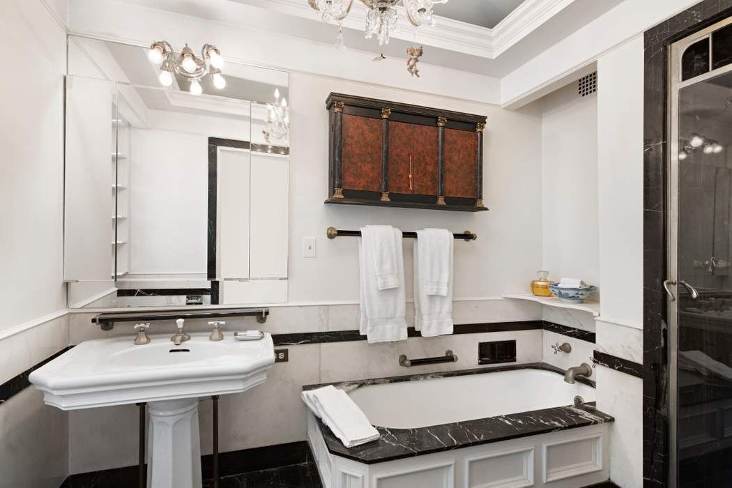 781 5th Avenue, Unit 614 Manhattan, NY 10022 - Photo 4 of 9 a bathroom with a sink double vanity and a mirror