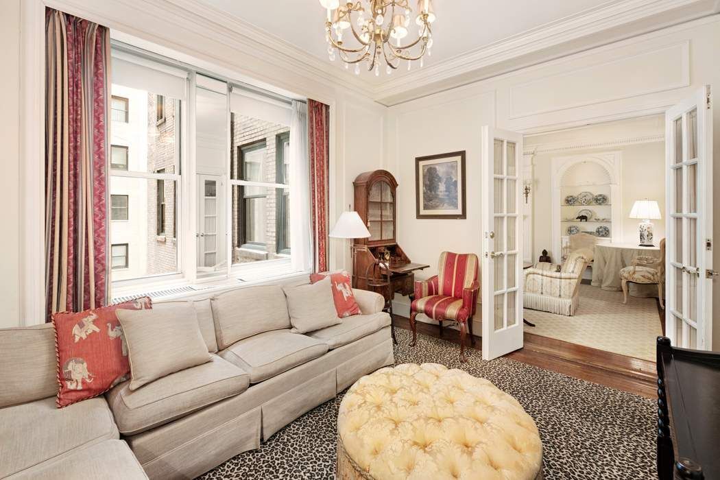 781 5th Avenue, Unit 614 Manhattan, NY 10022 - Photo 5 of 9 a living room with furniture and a large window