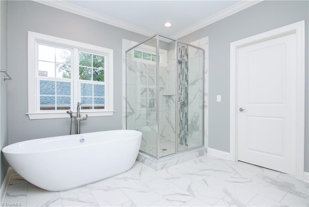 6010 Beckenham Way Oak Ridge, NC 27310 - Photo 12 of 25 Luxurious master bath with stand alone soaker tub and separate glass shower