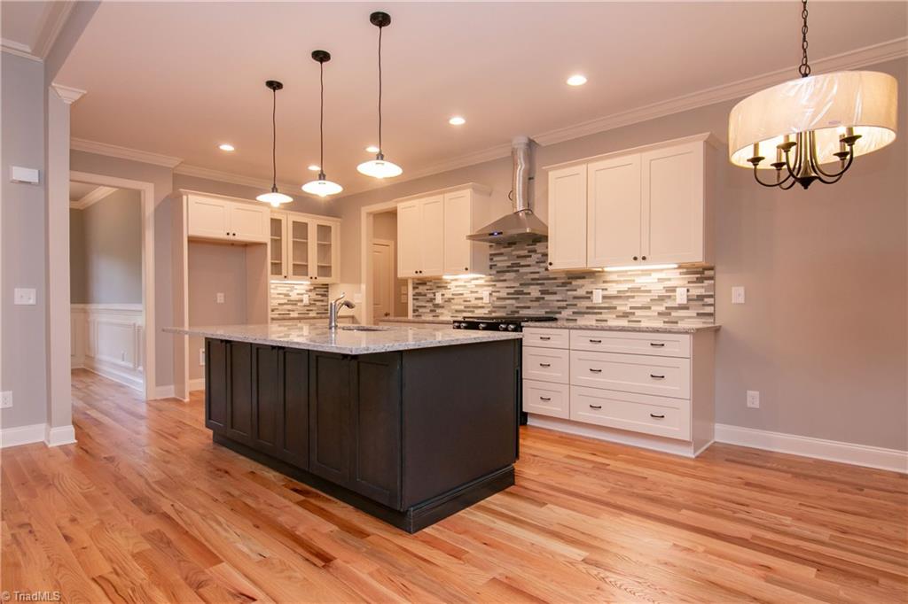 6010 Beckenham Way Oak Ridge, NC 27310 - Photo 7 of 25 Modern, sleek kitchen with granite and tile backsplash