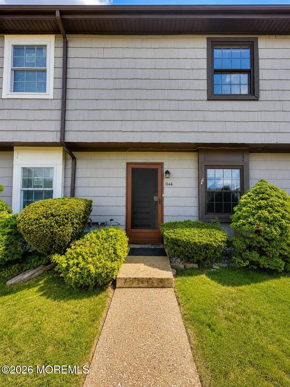 1144 Sawmill Road, Unit 121 Brick, NJ 08724 - Photo 1 of 23 a front view of a house with garden