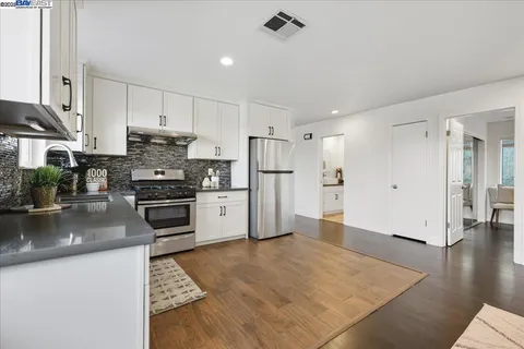a kitchen with stainless steel appliances a refrigerator sink and cabinets