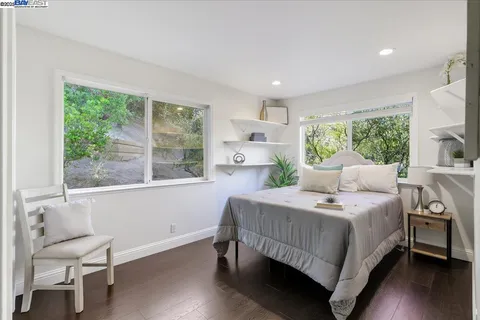 a bedroom with a bed and a large window