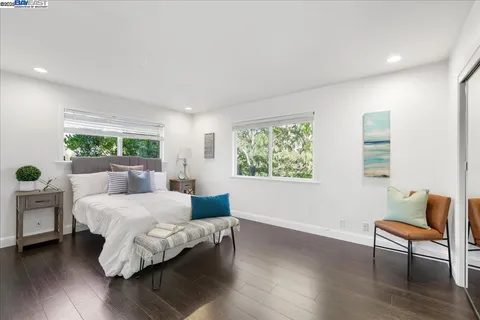 a living room with furniture and a large mirror