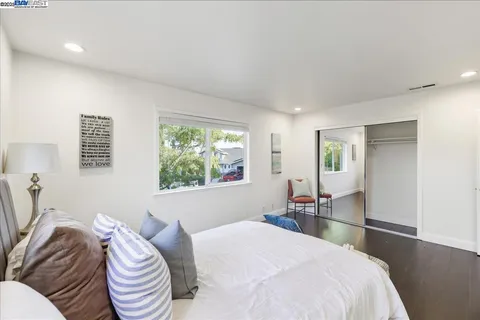 a bathroom with a granite countertop sink a mirror and a shower