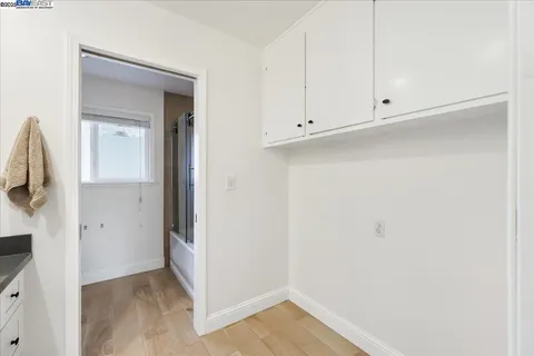 a view of a room with large windows and wooden floor