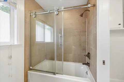 a view of staircase with wooden floor and white walls