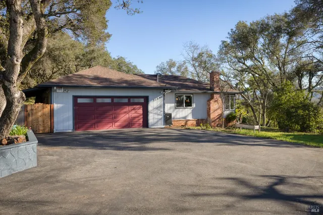 a view of a house with a yard and garage