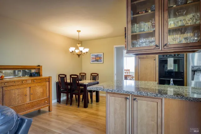 a view of a dining room with furniture and chandelier