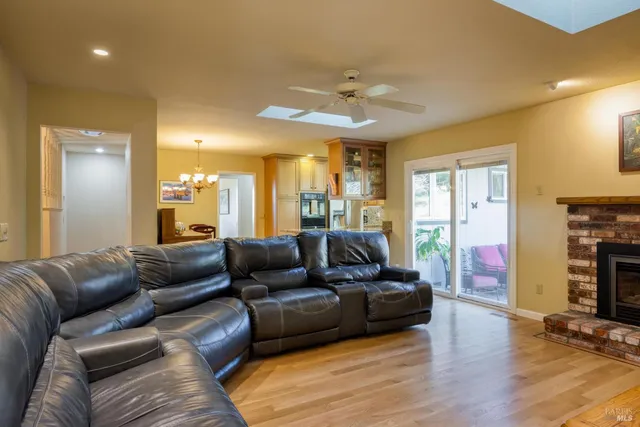 a living room with fireplace furniture and a wooden floor