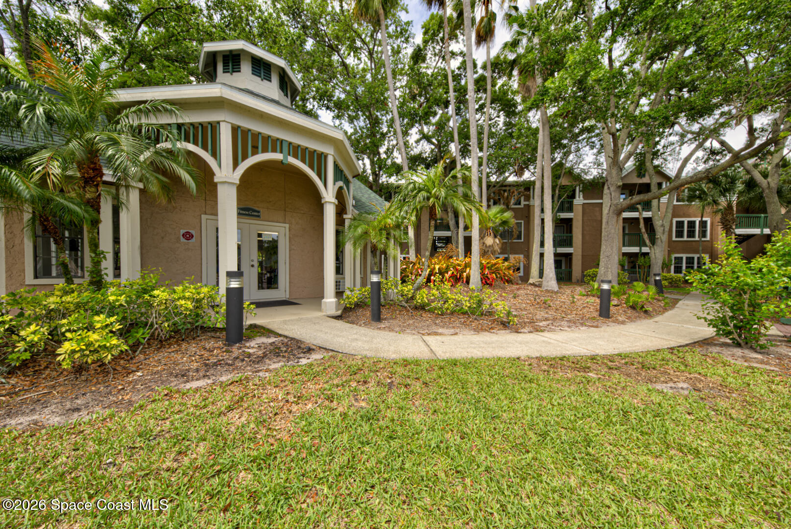 7667 North Wickham Road, Unit 1416 Melbourne, FL 32940 - Photo 35 of 41 a front view of a house with a garden