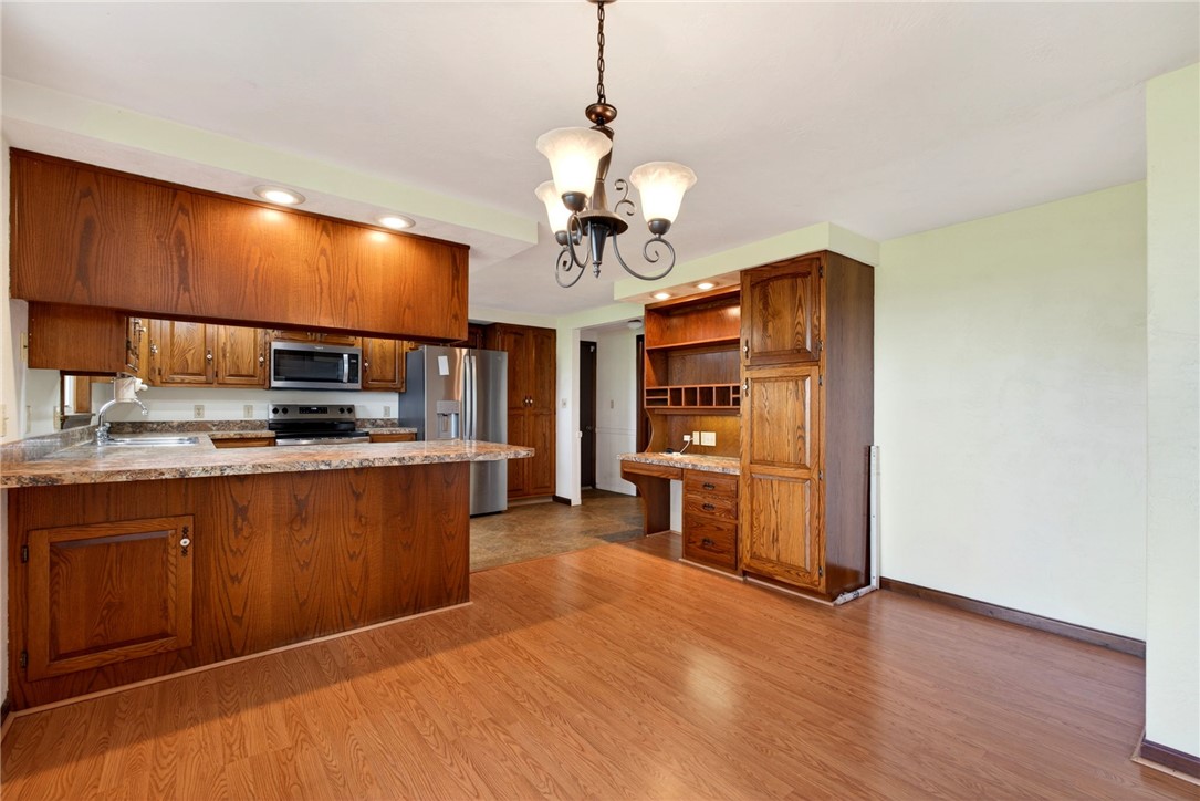 7988 McCool Road Greenville, OH 45331 - Photo 6 of 50 This spacious kitchen and dining area features warm wood cabinetry and a functional layout.