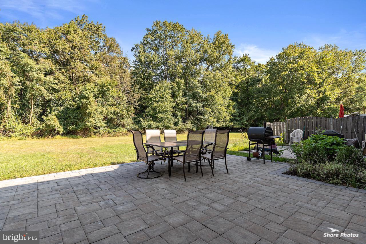 62 Stokes Road Mount Laurel, NJ 08054 - Photo 5 of 10 a view of a patio with table and chairs and potted plants with wooden fence