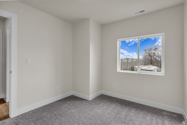 576 7th Avenue Midvale, UT 84047 - Photo 20 of 32 Carpeted spare room featuring baseboards