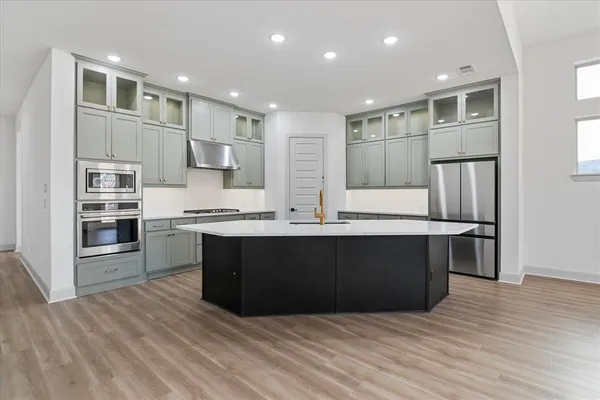 a kitchen with cabinets window and stainless steel appliances