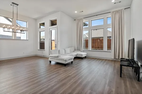 a living room with furniture and a wooden floor