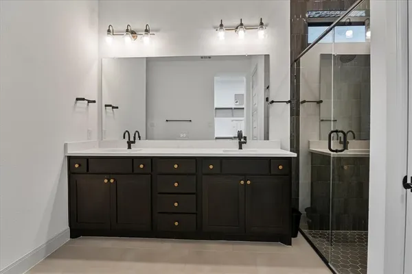 a bathroom with a double vanity sink and a mirror