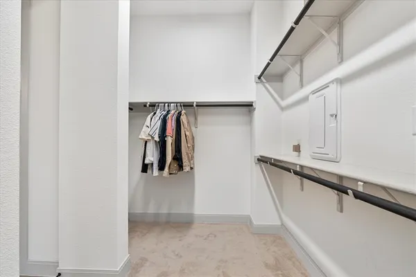 a view of walk in closet with clothes