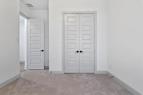 an empty room with closet area