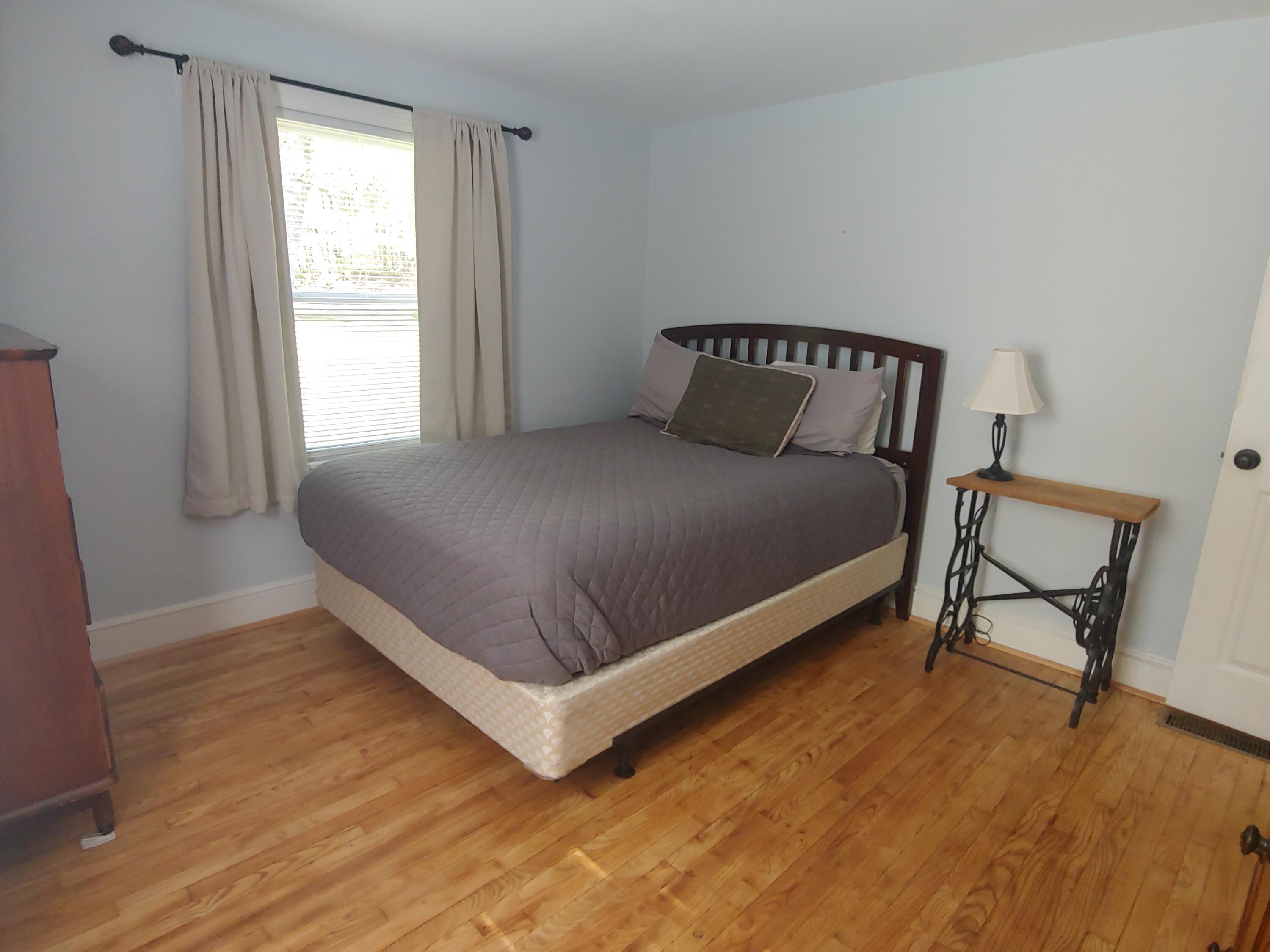 800 King Richard Road Ferrum, VA 24088 - Photo 11 of 17 a bed sitting in a bedroom next to a window