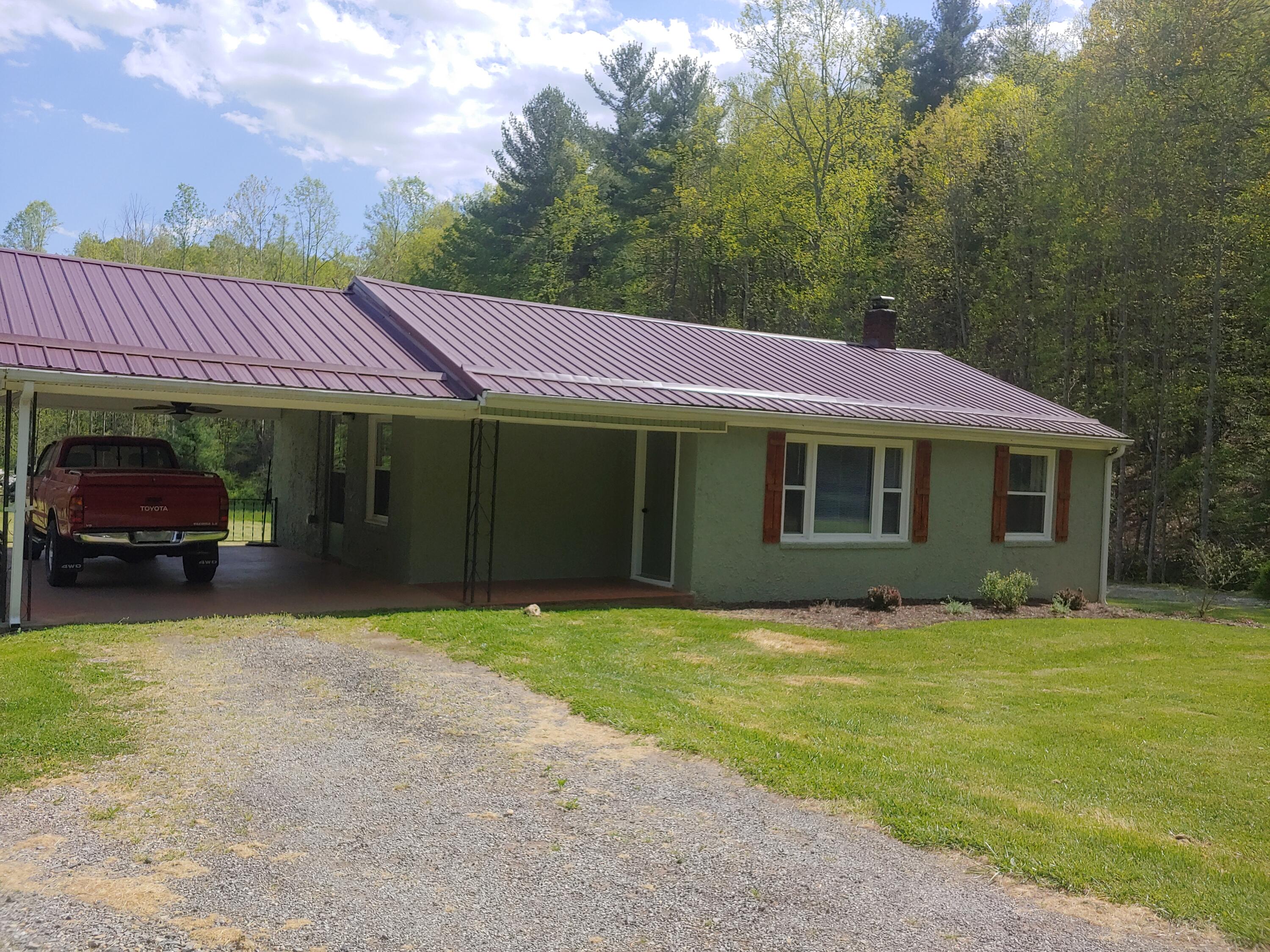 800 King Richard Road Ferrum, VA 24088 - Photo 2 of 17 a front view of a house with a garden and trees