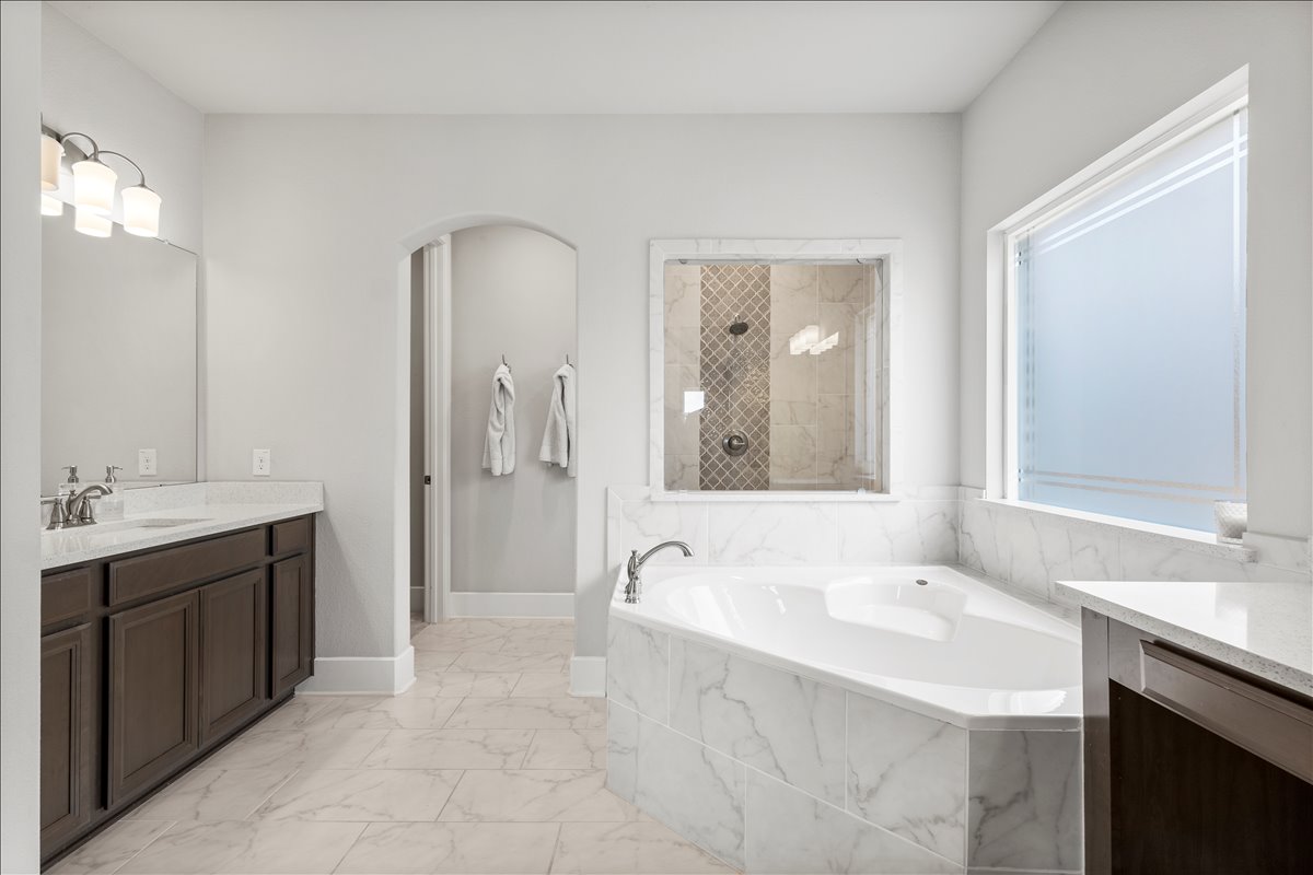 200 Draco Street Georgetown, TX 78628 - Photo 14 of 39 a spacious bathroom with a bathtub sink double and mirror