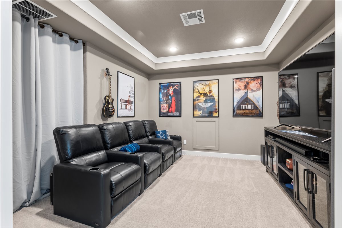 200 Draco Street Georgetown, TX 78628 - Photo 23 of 39 a living room with furniture and a flat screen tv