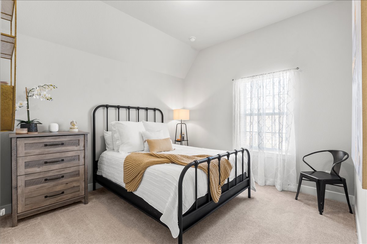 200 Draco Street Georgetown, TX 78628 - Photo 24 of 39 a bedroom with a bed and a window