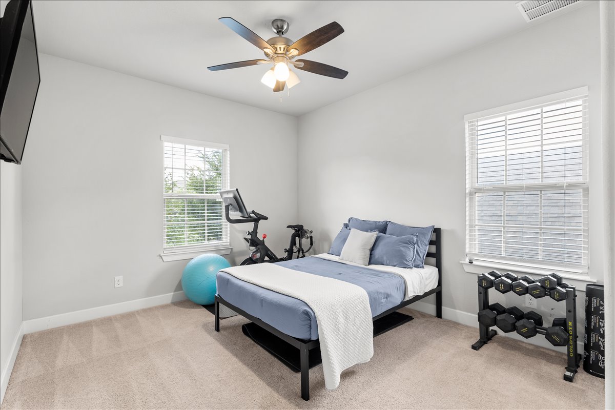 200 Draco Street Georgetown, TX 78628 - Photo 26 of 39 Bedroom 4 featuring light colored carpet and ceiling fan