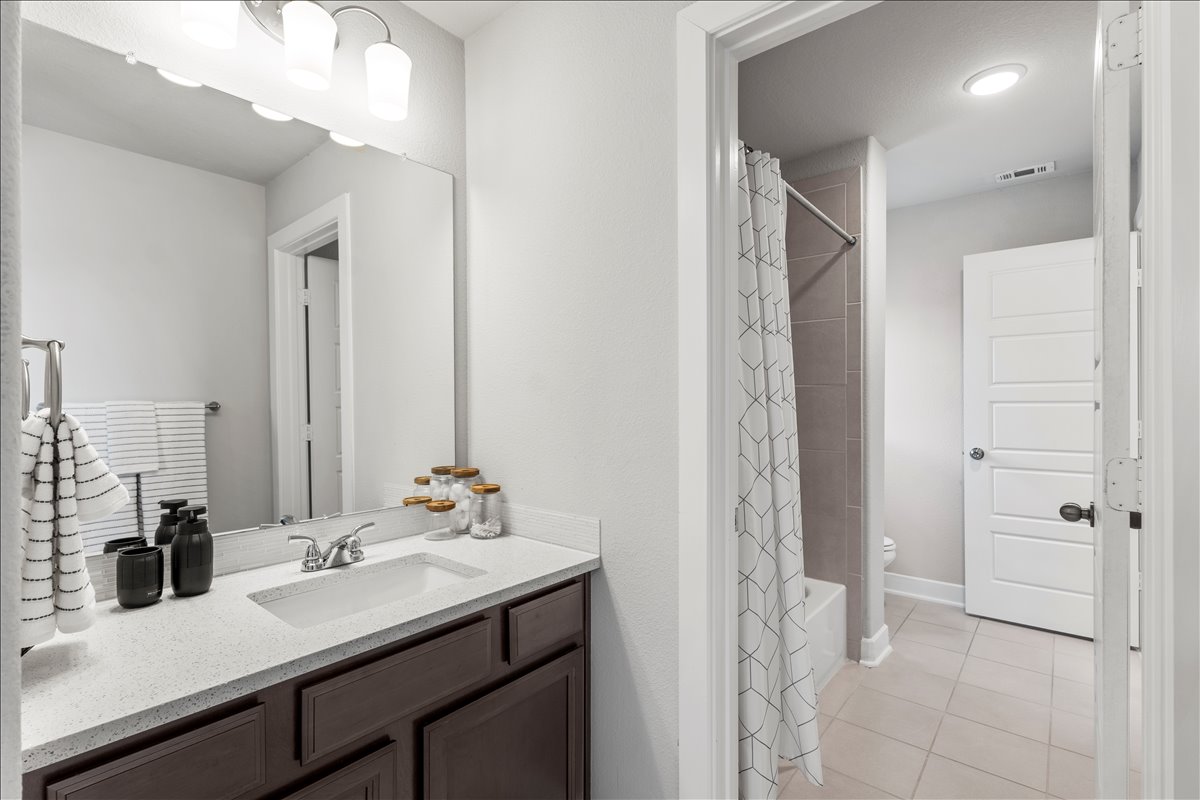 200 Draco Street Georgetown, TX 78628 - Photo 27 of 39 a bathroom with a sink and a mirror