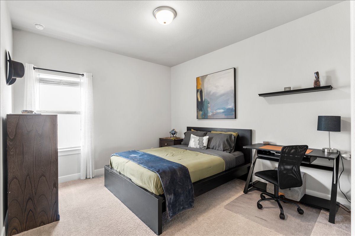 200 Draco Street Georgetown, TX 78628 - Photo 28 of 39 a bedroom with a bed and a desk