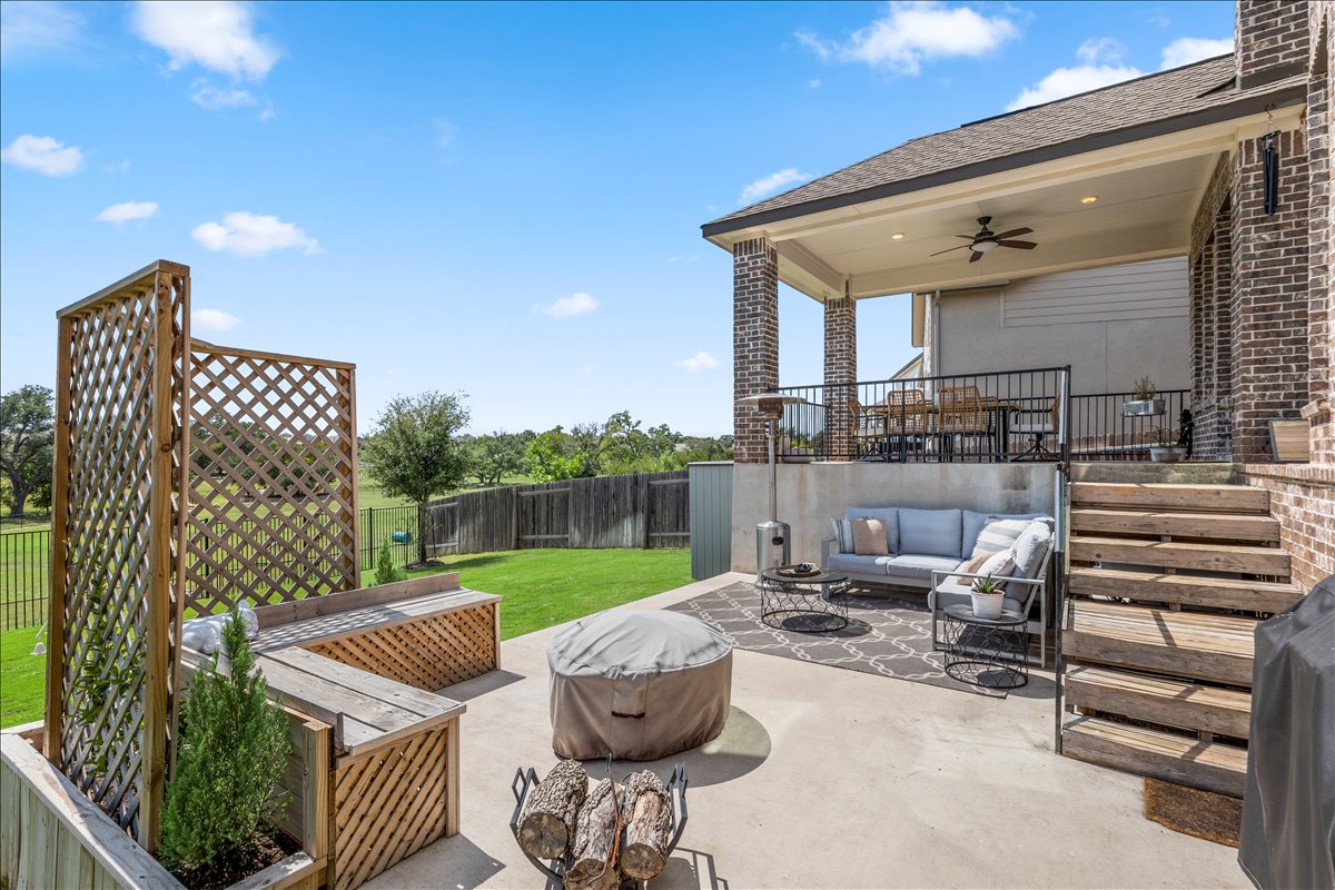 200 Draco Street Georgetown, TX 78628 - Photo 29 of 39 a view of a patio with couches chairs and wooden fence