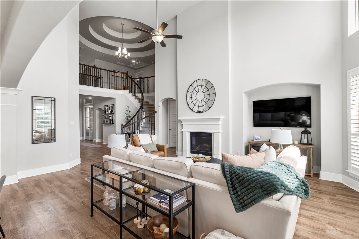 200 Draco Street Georgetown, TX 78628 - Photo 6 of 39 a living room with furniture a flat screen tv and a fireplace