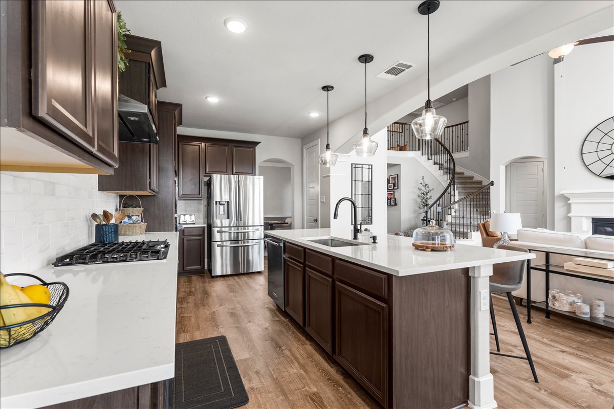 200 Draco Street Georgetown, TX 78628 - Photo 8 of 39 a kitchen with stainless steel appliances granite countertop a sink a stove and a refrigerator