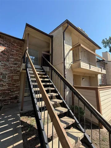 a view of a balcony with wooden floor and white walls