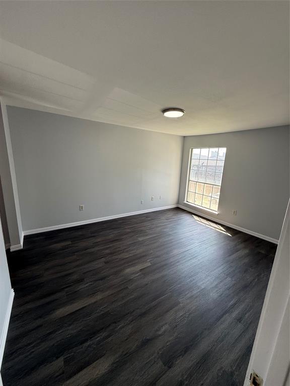 12482 Abrams Road, Unit 1427 Dallas, TX 75243 - Photo 4 of 10 a view of an empty room with wooden floor and a window