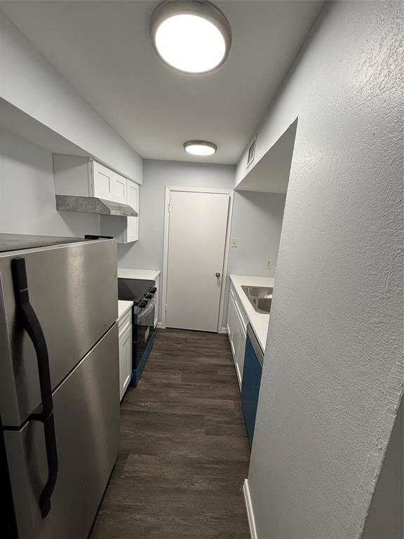 12482 Abrams Road, Unit 1427 Dallas, TX 75243 - Photo 7 of 10 a walk in closet with wooden floor and a sink