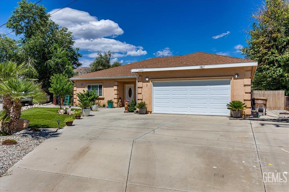 Undisclosed Address Tehachapi, CA 93561 - Photo 1 of 29 a front view of a house with a yard and garage